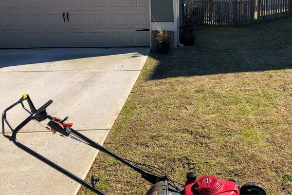 Lawn mower still in a customer's lawn after a lawn mowing service.
